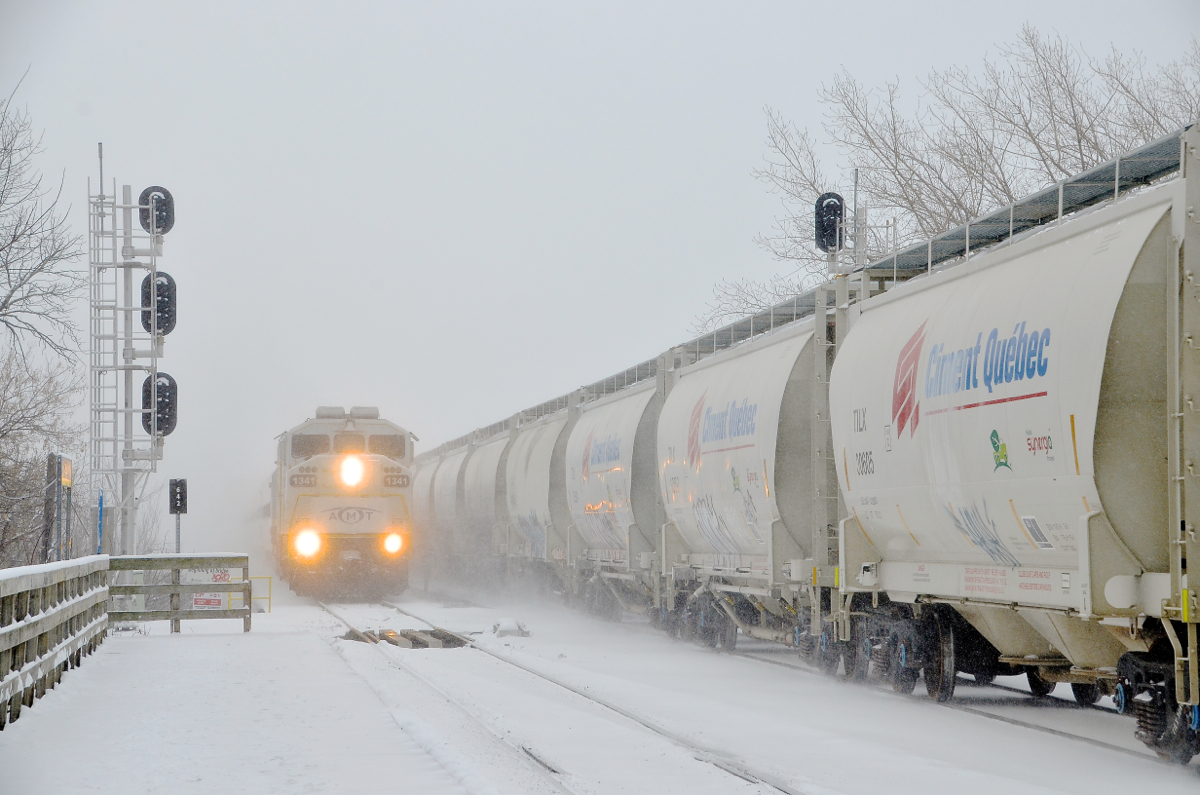 Two trains northbound over the St-Lawrence river. Two trains are crossing CP's bridge over the St-Lawrence river as they enter the island of Montreal. AMT 74 at left is about to stop at Lasalle Station with AMT 1341 leading, while CP 253 at right is on its way to St-Luc yard.