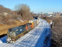 <b>BCOL/Zebra combo.</b> Montreal-area transfer CN 527 is through Montreal West with a lashup consisting of BCOL 4648 and faded zebra striped CN 4809.