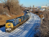 <b>CSXT power on CN 393.</b> CN 393 is returning from Richmond, Qc and interchange with the St. Lawrence and Atlantic Railroad with two CSXT GE's for power (CSXT 488 & CSXT 837) on a sunny but still cold afternoon. Normally CN 393 would return to Montreal in the middle of the night, but the crew had run out of hours in Richmond yesterday.