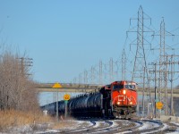 <b>Past the LRC speed limit signs.</b> CN 377 with CN 2621 leading is rounding a curve in Sainte-Anne-de-Bellevue, passing speed limit signs for VIA Rail trains having LRC consists in the process.