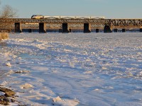 <b>It was as cold as it looks.</b> AMT 75 is crossing over the partially frozen St-Lawrence river on its way to Candiac after making its station stop at Lasalle. With a strong wind blowing off the river, it was a very cold wait for the train (though thankfully not a long one).
