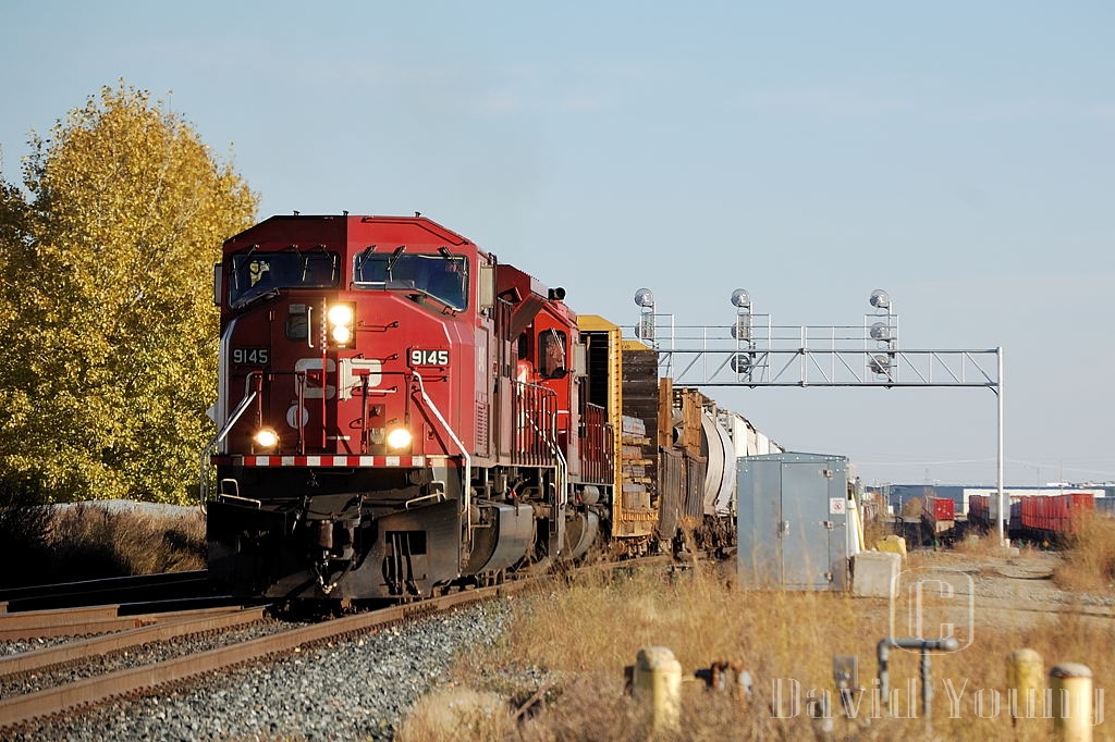 CP 9145 West pulls ahead while the conductor makes his cut on his head end chunk of cars. They will pull west over the crossovers, and get a light to return east and begin their work in the Shepard intermodal terminal, in the east end of Calgary.
