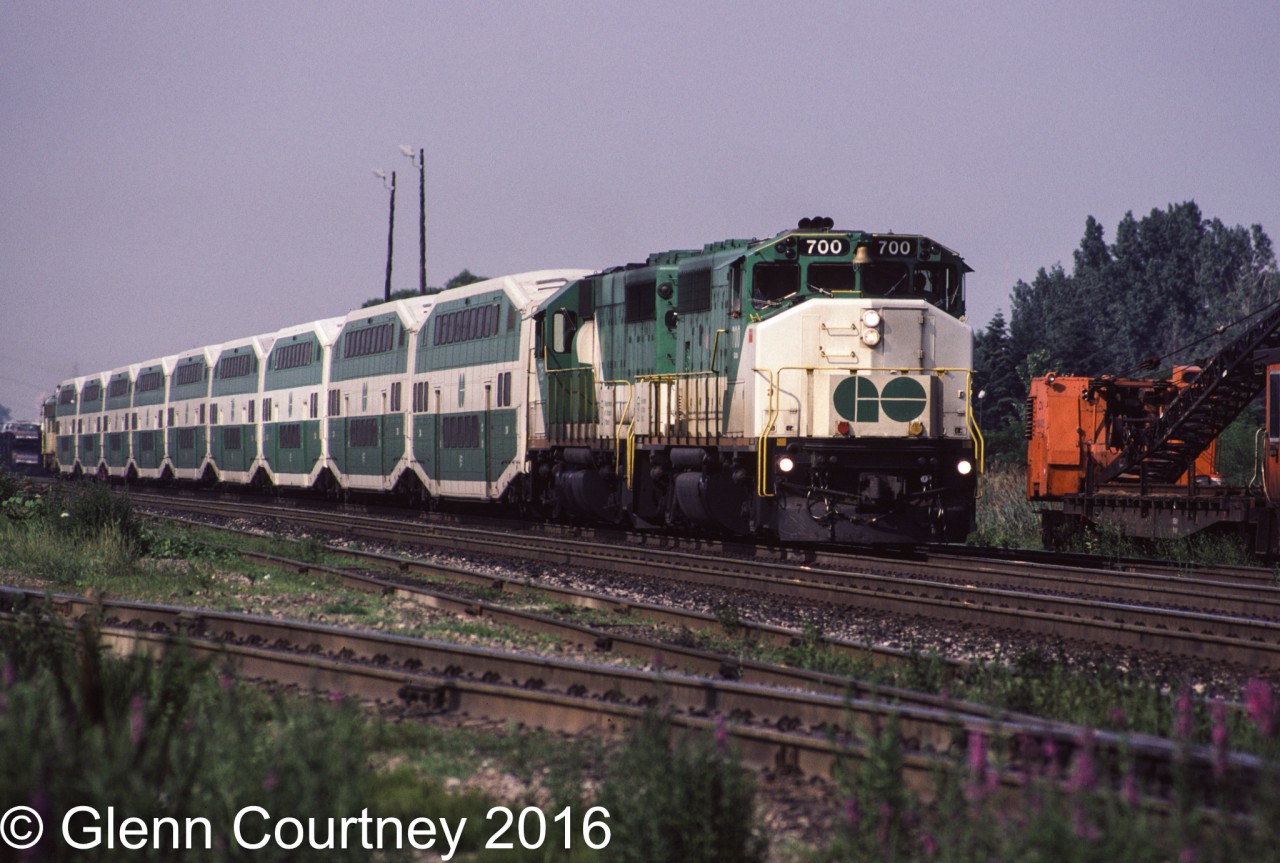 GO GP40-2W 700 (bought new by GO) and a former Rock Island GP40 lead a nine car westbound train past Oakville Yard.