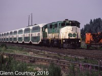 GO GP40-2W 700 (bought new by GO) and a former Rock Island GP40 lead a nine car westbound train past Oakville Yard. 