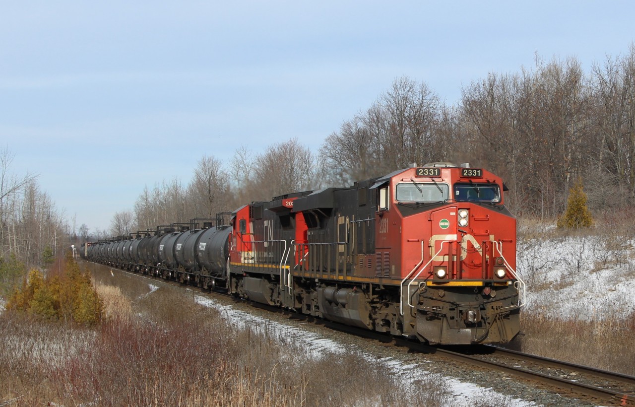 CN 2331 leads CN 2032 down the Halton sub. past MM30 and about to cross side road 10 on its way in to Milton with a mixed load a freight and a brand new GO Metrolinx engine #312 at the tail end.