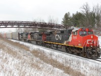  On a very cold afternoon, CN 2593 leads CN 2199 and CN 2466 around the bend and under the Glencairn golf bridge as they are about to cross #10 Sideroad and pass MM30 on the Halton Sub.