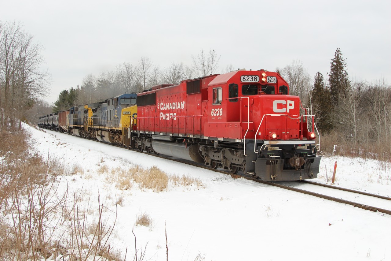 Ex SOO and now CP 6238 along with CFX 512 and CFX 56 exit Guelph Junction and power up to head down the Hamilton sub as they are  about to cross side road #3 and MM 75.11.