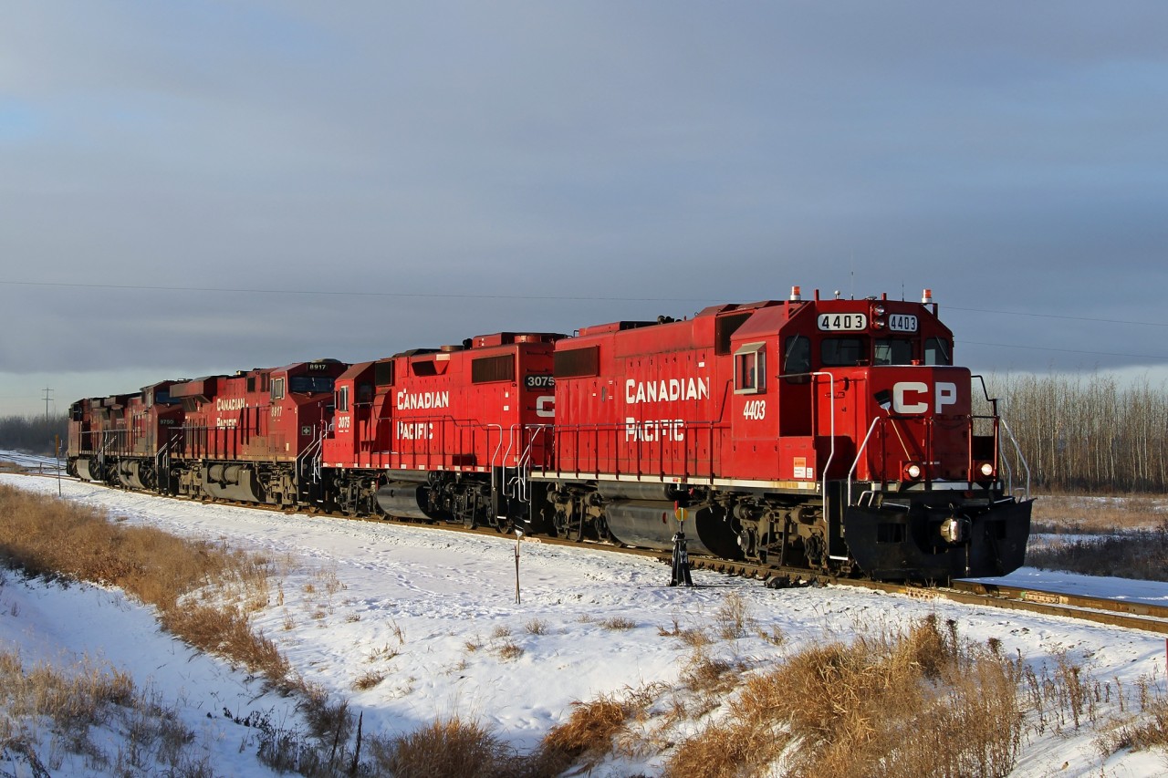 Former SOO GP38-2 4403 along with GP38-2 3075, ES44AC 8917 and AC4400CW 9750 make a light engine move to Kinder Morgan's Rail Terminal in east Edmonton.