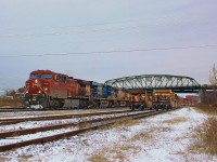 The first ordered CP 143 of 2016 has a pretty decent lashup with CP 9639, CSX 5464 and UP 5545. 143 is a little later than usual, and is often through Fort Erie by 9am. 
<br>
<br>
A lot has changed in Fort Erie in the past couple of years, and the biggest change has yet to come. Last year CN consolidated most yard operations from Fort Erie to Port Robinson, making this yard quite dead, and void of any CN power. The yard has been used for storage since then (much like Niagara Falls was before being torn up). With rail traffic quite slow recently due to a 'technical' recession, the yard is crammed full, with unique twin stack well cars making up the mix at the east end of the yard. The twin stacks were among the first well cars to accommodate double stack intermodal, and their technology is now redundant. 
<br>
<br>
Fort Erie is about to lose one of Niagara's more iconic bridges, the Central Avenue bridge in the background. The handrails on the east side of the bridge are already being dismantled, and the entire bridge will be replaced by the end of the summer. The truss structure is expected to come down sometime in April or May, ending its 63 year history. Until then, get your shots, as a few months goes by quickly.