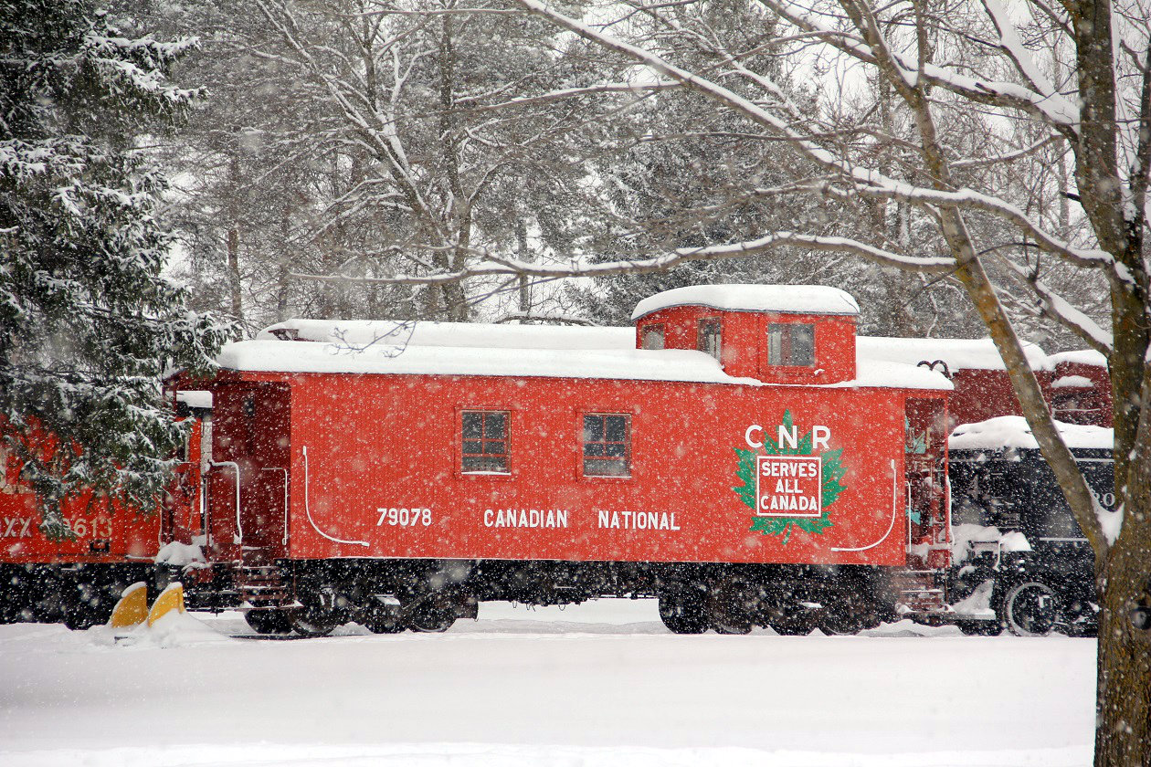 During a heavy snow fall, CN van 79078 looks piece full almost Christmas card like as it sits on display in Lindsay. Other equipment there includes another CN caboose, a few box cars, a CN GM-switcher and TH&B steam engine. The Lindsay train group have done a very nice job preserving this equipment. Worth the drive to have lunch in the park ( summer ) next to the display and admire the past. Taken from the Home Hardware parking lot.