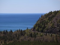 The first full day of my visit to Canada in 2015, June 5 started off miserable with the clouds hanging very low above Marathon on the north shore of Lake Superior. I was in for a very slow and cold start. While waiting for a train it seemed that the clouds were dispersing. So it happened. The first of two eastbounds arrived under a cover of clouds. After a meet with one westbound I was able to get the one shot I had been waiting for a number of years to take. The eastbound drag with 9657, 9360 and 3085 is seen rounding the bend before crossing the Little Pic River with the expanse of Lake Superior in the background. 