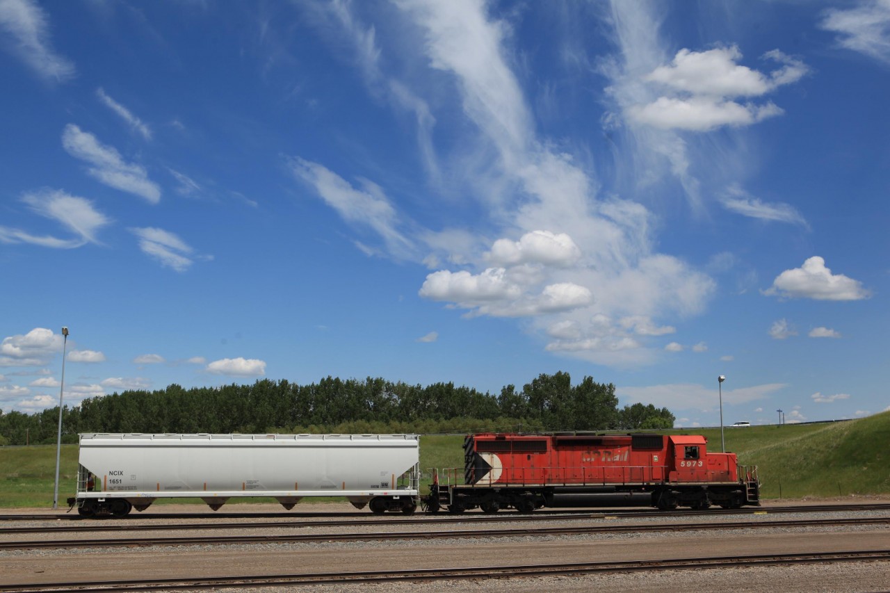 Canadian Pacific's SD40-2s are getting rare these days. 5973 has been relagated to yard duties in the Lethbridge yard. On June 13 a fairly strong wind blew the clouds from a low pressure system up in Calgary into a sutherly direction creating some remarkable veils up in the sky.