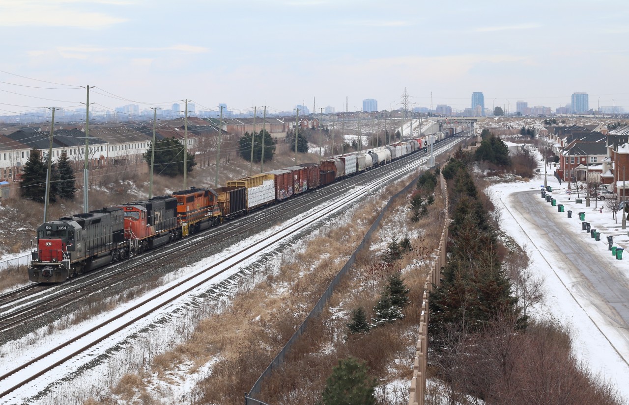 Goderich Exeter train 431 with a borrowed CN SD75 is hot on CN train 435s block as it is about to duck under the Hwy 7 underpass at Mount Pleasant in Brampton's west end.