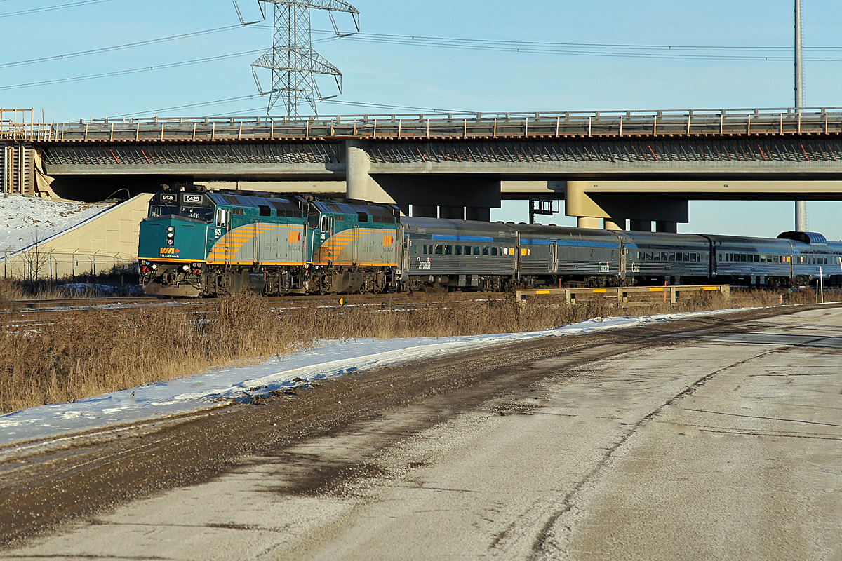VIA #1 "The Canadian" running 8 1/2 hours late heads through Clover Bar under the new Anthony Henday Bridge, replacing the old 1st Street grade crossing.  A rare treat these days to see the Via at this location in daylight, even if the passengers are a little frustrated with the delay.