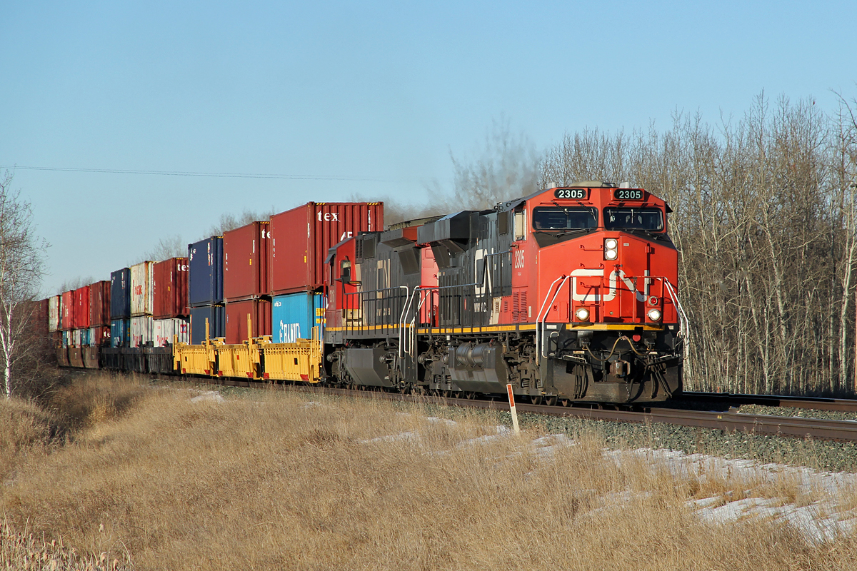 Heading east towards Uncas are ES44DC CN 2305 and Dash 8-40C CN 2016 (ex UP, ex CNW)