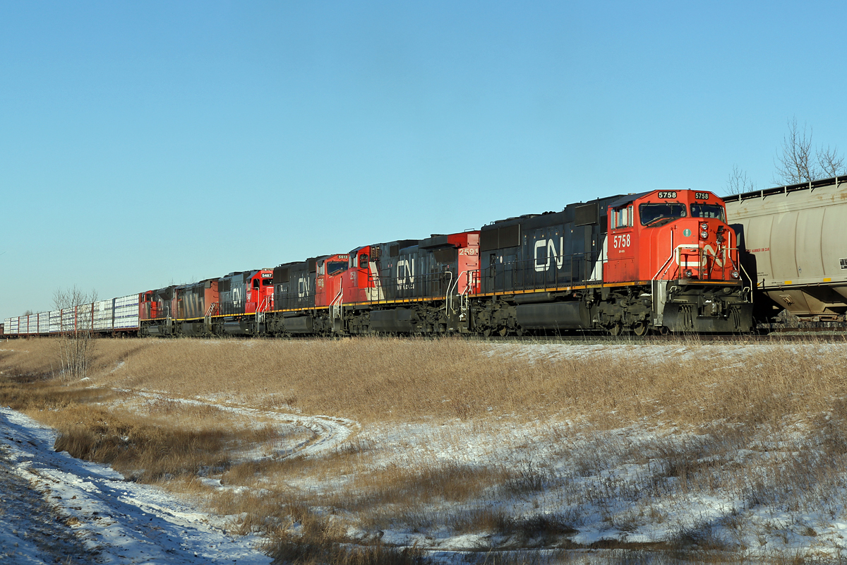 Heading east up the hill at Ardrossa this train has lots of power representing 6 different types.  In the lead is SD75I CN 5758, followed by Dash 9-44CW CN 2591, SD70I CN5613, SD60 CN 5487, Dash 8-40CM CN 2418 and SD70M-2 CN 8805.