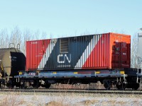 Sitting mid-train in a westbound is one of CN's Distributed Brake Containers, CNSU 0009, mounted on its own flatcar CN 0009.