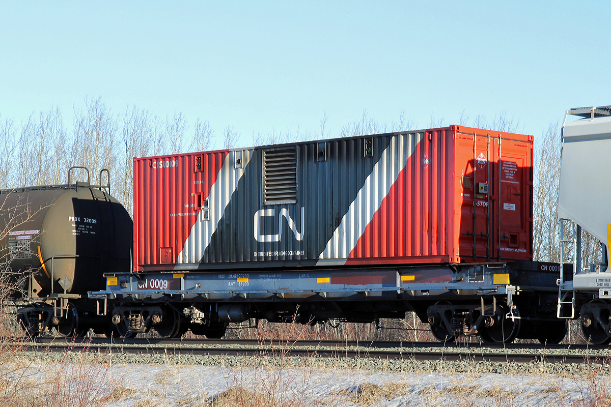 Sitting mid-train in a westbound is one of CN's Distributed Brake Containers, CNSU 0009, mounted on its own flatcar CN 0009.