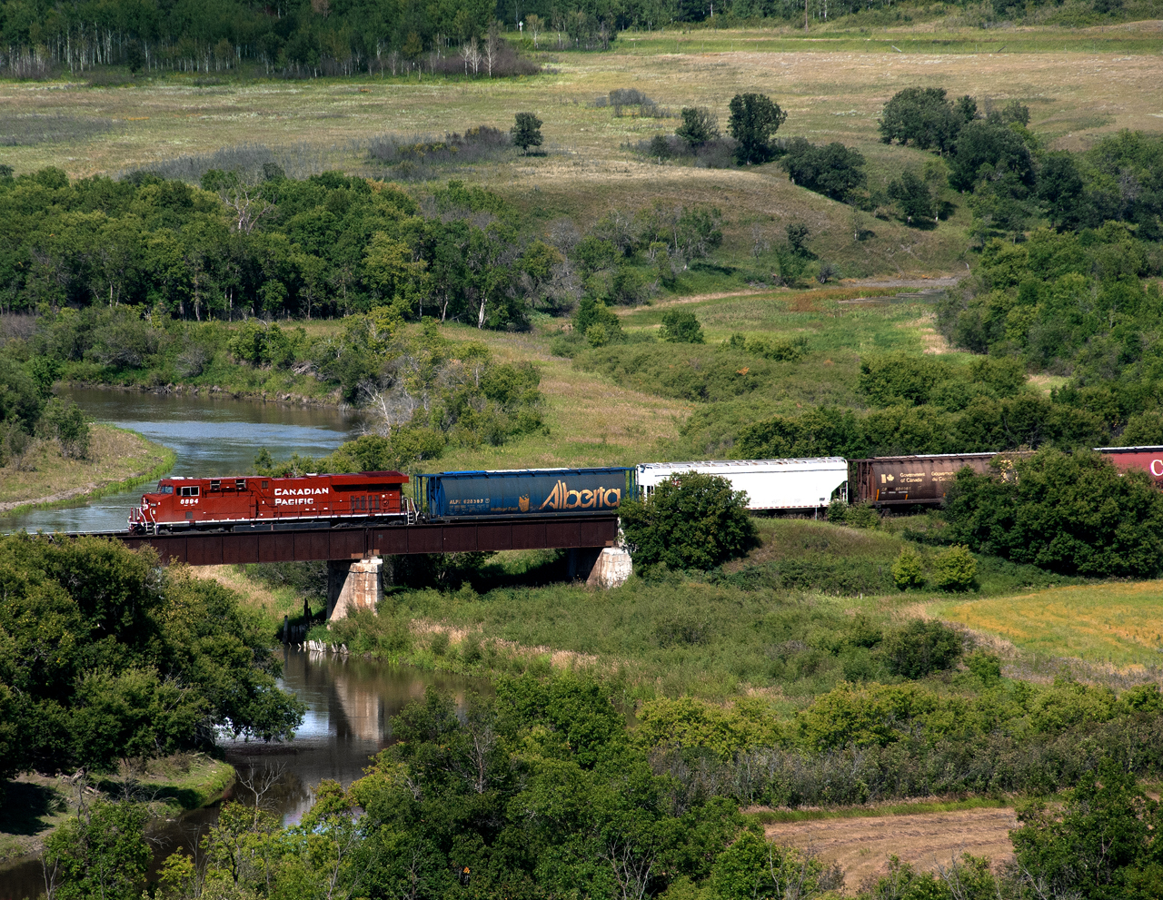 Westbound grain empties on CP's Winnipeg-Edmonton North Main crosses the Assiniboine River near the Saskatchewan boundary on the Bredenbury Subdivision