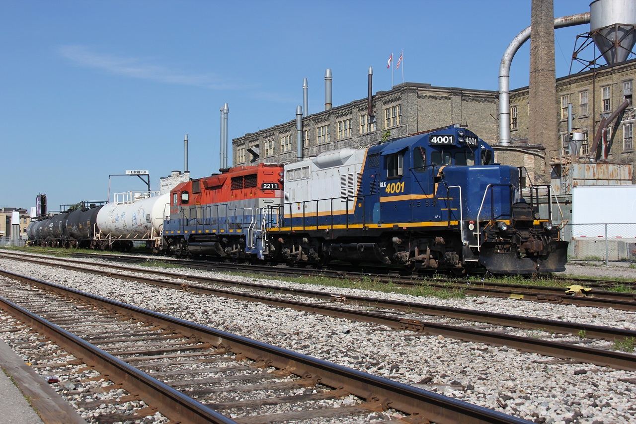 RLK 4001 and RLK 2211 rest peacefully at the Kitchener VIA/GO/GEXR Station along with a string of 5 tank cars on a summer morning in late July 2015. This is train to Elmira that runs along the GEXR Waterloo Spur (symbol GEXR 584?). RLK 4001 is no longer with GEXR; however, 2211 soldiers on powering 580 these days.