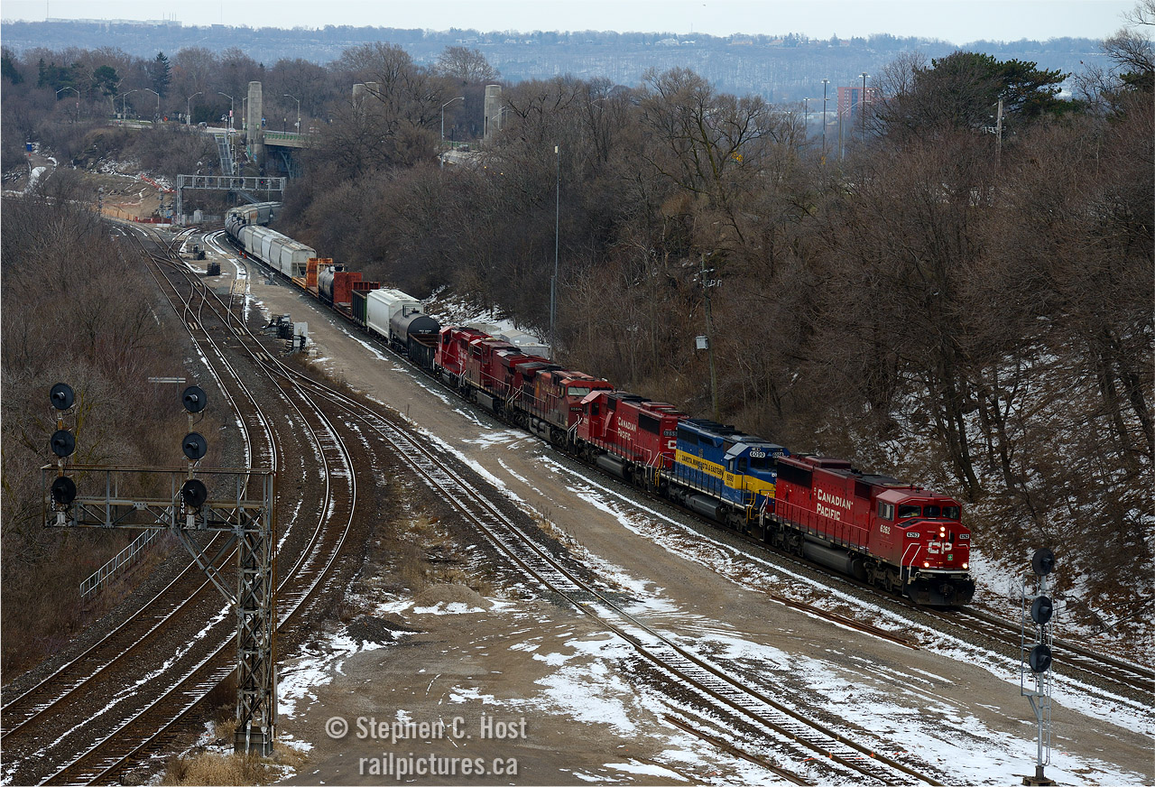 The desjardins canal area is seen in full, a tight mashup of three railways, a roadway and high level bridge (York Rd in the background) and a six lane highway, with an essentially disused Canal right through it. A Transportation fan's mecca, and we're part of that company aren't we.
I call this a Mooney:  a shot from waay up high, as far and high as one can get without being a squirrel.. a nod to our friend who has inspired different angles (I recall the ACR Sinter plant shot as one such example) 
This is train 255-02, the first three engines have been going back and forth on 255/254 the last few days at least, I managed to see this trio on a chance encounter on New Years Eve heading east with the 6255 in the lead, and would have anticipated it yesterday on the return from Buffalo but 255-01 was abolished. We'll have to see if this power returns.. possibly tomorrow!