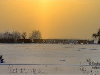 Almost home, Goderich-Exeter's daily Goderich wayfreight is passing eastward by the warm glow of a winter sun, a pillar of orange from ground to sky created by light flurries refracting sunlight in all directions. Framed in a tree, GEXR 55413 brings up the rear as the crew performed the first plow run of the season westward earlier this morning.