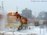 <b>Look out for the Smoking Locomotive</b> The sign at right should say. SD40-2 3394 is lost in a puff of brakeshoe smoke following the 4% downward grade from the Goderich Station to port. In the background are a couple dozen loaded Salt cars waiting to climb 130 vertical feet to the station, and onward to Stratford. The motive power and crew could only muster 5 cars up the hill after numerous attempts, starting with 11 loads. Also seen are two ships, the Federal "Frontenac" and Algoma Central "Algomarine", Goderich truly is one active port of call for all modes of transport.