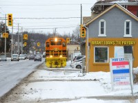<b>Want a loan? Need a Loan?</b> RLHH 496 trundles along Clarence St past some of Brantfords finest downtown establishments, with green arrows indicating clear signals for both the railway and cars. <br><br>Funny Story, A bit earlier I was with Rob Smith waiting for the train who was discussing with me when 496 would make its appearance. Time kept ticking and lunch was nearly over. Rob said "I have to pull a Mooney and go.. which means as soon as I leave the train will come". Rob left, and sure enough so the train came. How our friend Arnold got wrapped into this is a thing of legend, but I'll let the legend himself comment below to how this Mooney-ism came to be :)<br><br>I don't make the trip to Brantford often, only once or twice a year, but I was lucky this day as they were 5 hours late allowing me the chance to catch them during an afternoon off. To me this really is a time machine, being a SOR (RLHH) operation, and having missed the first time RLHH operated this spur from 1997 to 2000 or so.. with just a single customer, this could last for decades, it could last for months, you just never know. Glad to have shot it!