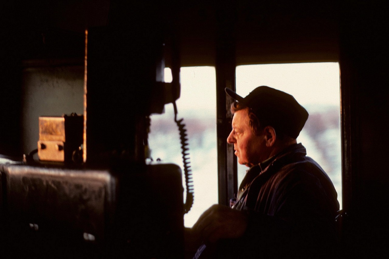 We're aboard CP GP35 5012 - today it was leading the "Starlight" - CP's daily Agincourt Yard to TH&B Aberdeen Yard turn- back in the 70's. Legendary Hamilton pool hogger Frank "Smokey" Anderson looks into the late afternoon winter sun, heading westward, somewhere on the CN Oakville Sub with a look of disgust...as the CN, once again, isn't co-operative with green signals. Smokey was a regular on the "Kinnear", the "Starlight", "Extra Hams" and Acid trains...and his distinctive voice was unmistakable one the radio. Back then, as the train would pass through curves...the tail-end would be heard on the radio "all black on the south side Starlight" meaning they couldn't see any potential hot boxes/sticking brakes.