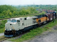 The Talbotville-Buffalo autoparts train that used to feature out-of-the-ordinary power so frequently had something a little different this day. A "Stealth" NS unit 9867 leading UP 8605. The unpainted version of the Dash-9 was not all that uncommon.As fast as GE was pumping them out, NS was pressing them into service. As this image indicates, even before they got painted. This train and its' counterpart, #327, were discontinued at the end of 2006.
