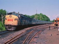 It was a really hot day in August, and we were in town for a few days. So what else to do but wander over to the station and see what was happening? Turns out Southbound Canadian was close by, so driving under the bridge and up the other side for a photo was the thing to do. My old jalopy had no a/c save for all the holes in it, so the Sidekick got out of this rolling sauna tank and watched the proceedings. VIA #10 is rather lengthy this day; power up front is 6505, 5532 and 6622. Car count looks to be about 10. The Sidekick, looking ahead to a potential future of trains and travel and other related nonsense, became discombobulated and eventually fled. On the ground alongside, having a break from heavy usage, is the beloved Speed Graphic. The camera still resides with its owner, although both retired. :o)  