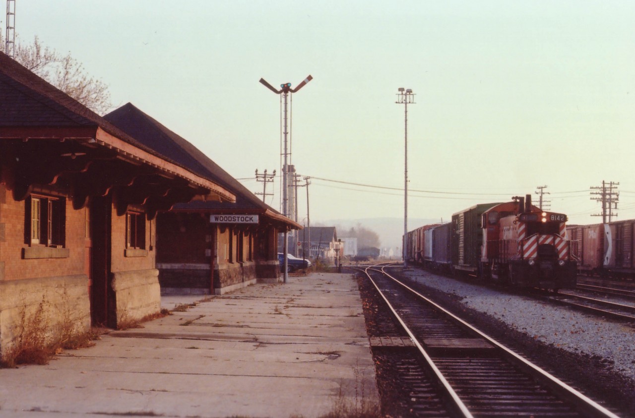 CP 8142, an SW1200RS, (now all off the CP roster) slows to a stop at the old Woodstock CP station. I do forget whether he was just getting papers to leave or whether he had come in for the day. I do recall it being warm for this late in the year; a nice end to the day was this "mood shot" before I headed back home. One can almost feel the peacefulness of the scene.  The MoW building on the left has long since been demolished, and the mainline has been shifted well away from the station. Woodstock CP station still stands, an all-purpose building; including usage as an office for the OSR when they come into town to switch with the CP.  CP 8142, built way back in 1959, now toils for the Black River & Western in New Jersey.