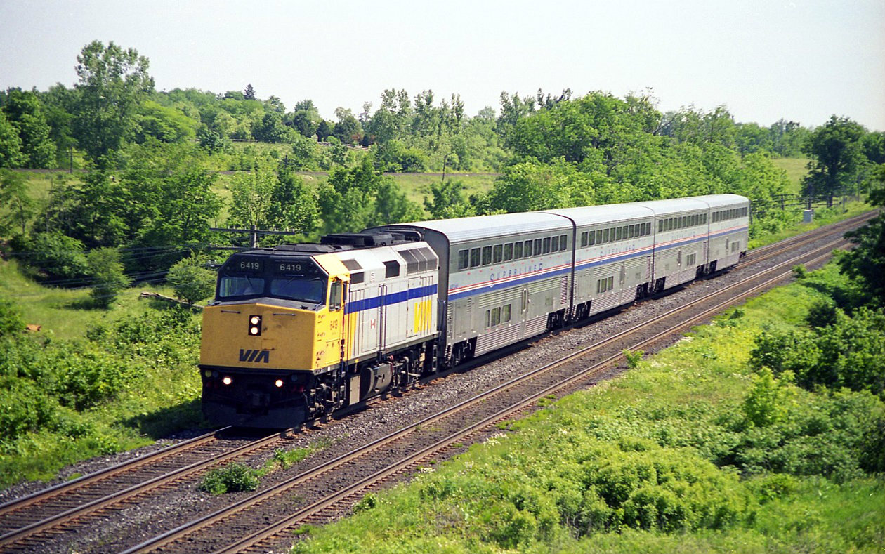 The Via/Amtrak International Wb passing threw Hype Park. With Via 6419 and four super-liner cars. Headed for Sarnia, Port Huron and onto Chicago. Amtrak F40,s and Pepsi can GE,s where also used for power with the super-liner cars. Would have liked to have seen an LRC and super-liner consist. The CP Windsor maim can be seen just above the train.