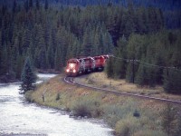 4 SD40's lean into Morants Curve and an oblivious fisherman stares into the Bow River. What's behind you DOES matter.