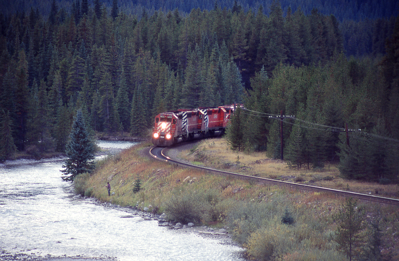 4 SD40's lean into Morants Curve and an oblivious fisherman stares into the Bow River. What's behind you DOES matter.