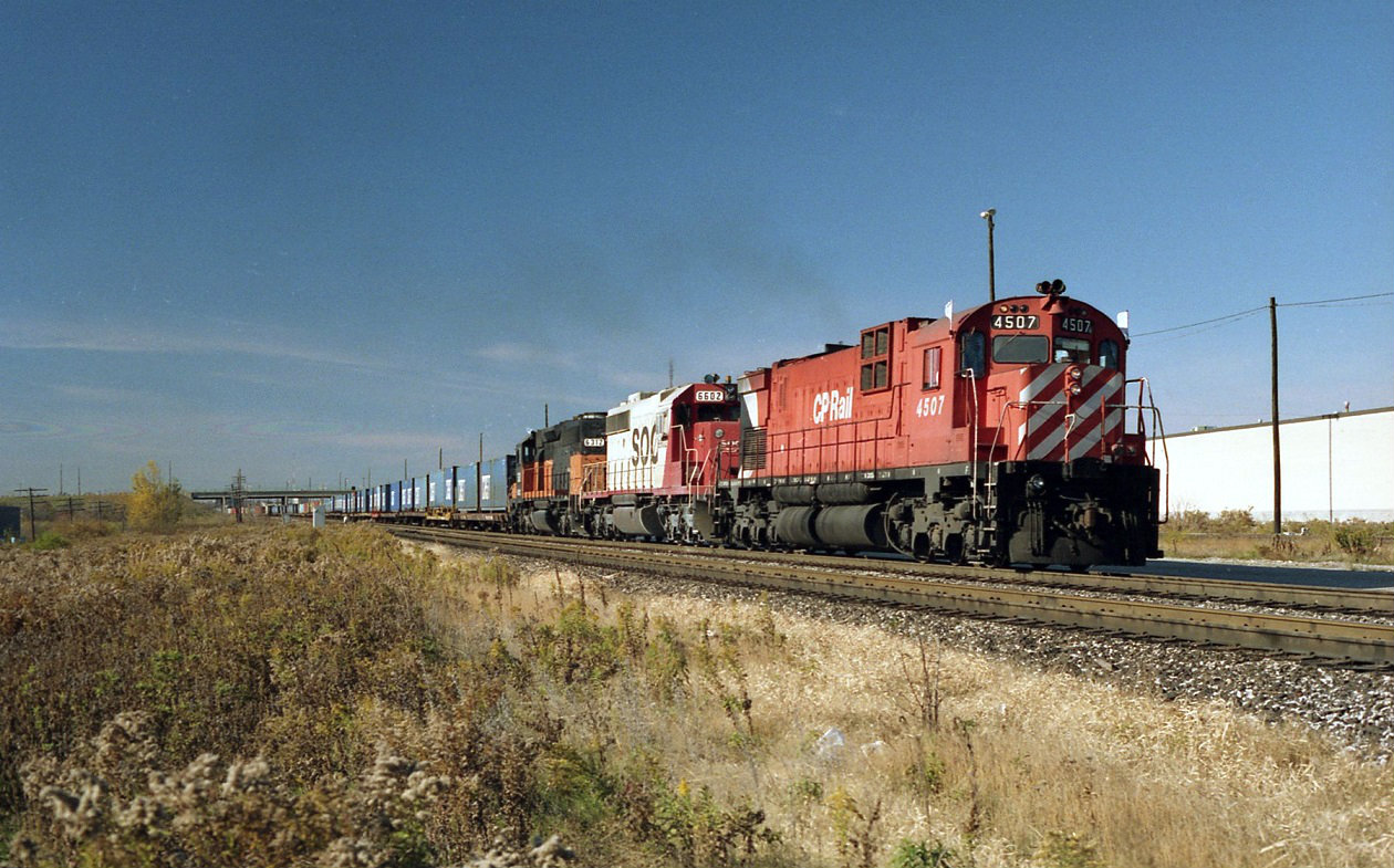 Extra 502 begins to accelerate after the crew change east of Markham road. A steam tradition carried over, white flags and class lights symbolize an extra. The last unit, a bandit SOO 6312 ex Milwaukee road SD40-2. These units showed up in Canada  for only a few months before being sold off or returned to the leasing companies .