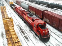 CP 3028 (GP38-2) and CP 1128 (GP35 Slug, Retired) are in the middle of doing some switching at Winnipeg Yard on a cold, winter day.