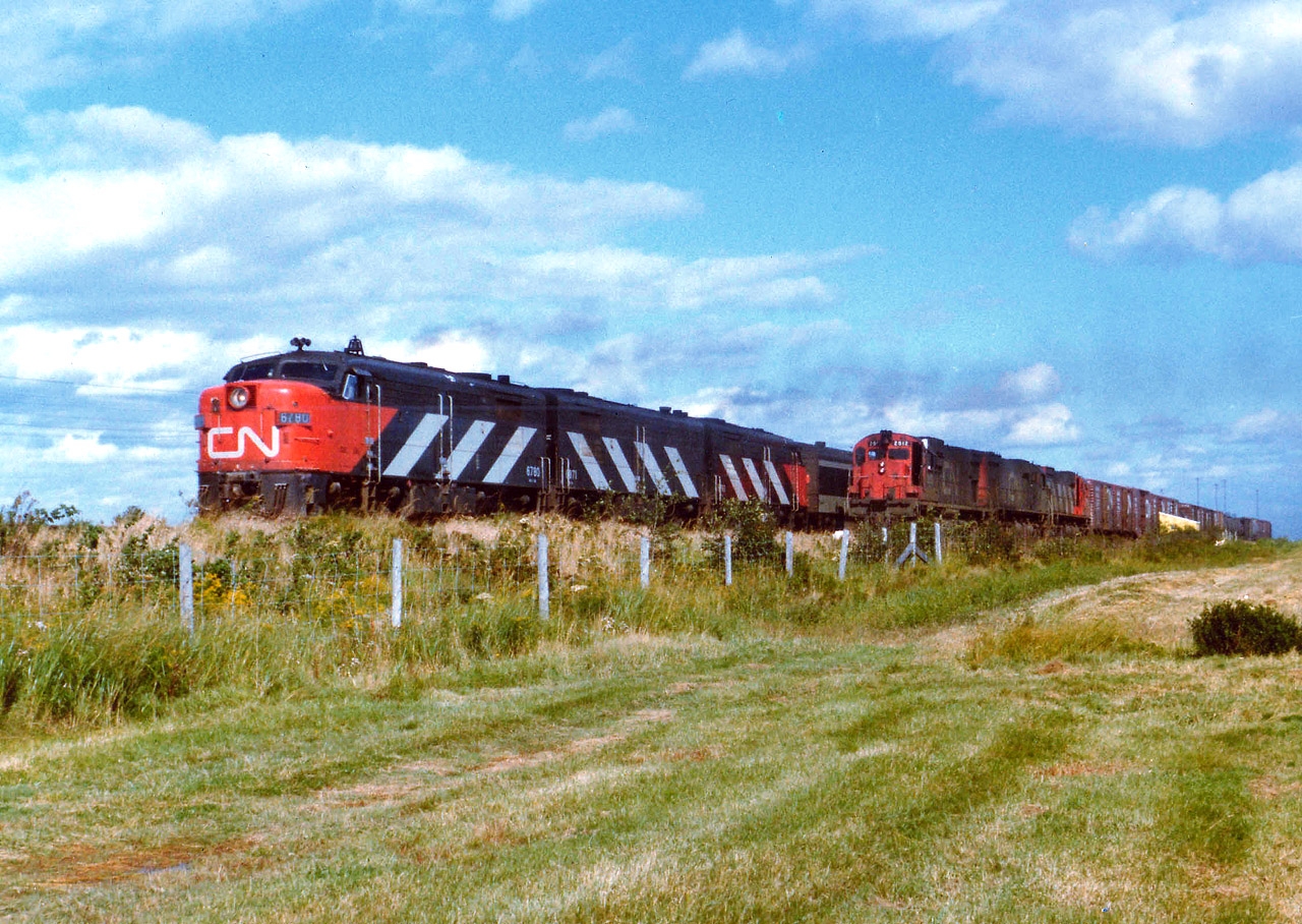 For the life of me I cannot recall just where I shot this image. My notes say "Sackville", but I do not recall a siding there. At least not out in the countryside. Would appreciate input. This scene shows the Ocean Limited with CN 6780, 6871 and 6761 passing westbound CN freight in the hole with CN 2012, 2337 and 2320. This was one lucky catch, considering how few trains I did manage in this part of the country.