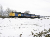 Note the date. This is mid-May! It happens periodically. Alberta will get a Spring snow storm that will dump 10 -20 cm of snow.
Operations on the CP were definitely affected. There was not much running, but the eastbound "Canadian" arrived about an hour late. I don't think that I saw the westbound version in the time I hung out by the tracks.
It is about to cross the Bow River.