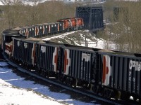 The first CP eastbound train through this area after a May snow storm. It picked up a string of gondolas full of aggregate from the Exshaw quarry/cement plant.
By now, the temperature had risen and the sun was out, resulting in significant snow melt.