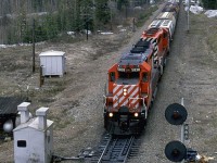 This westbound manifest has left the Connaught Tunnel behind and is on the long grade into Revelstoke. It is about to pass under the Trans Canada Highway. 