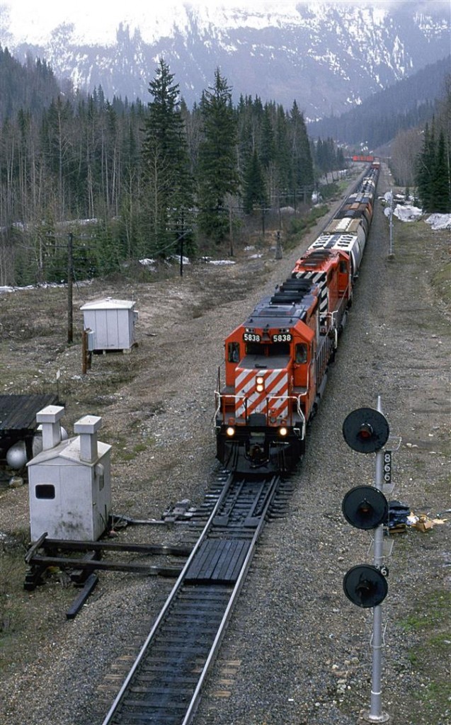This westbound manifest has left the Connaught Tunnel behind and is on the long grade into Revelstoke. It is about to pass under the Trans Canada Highway.
