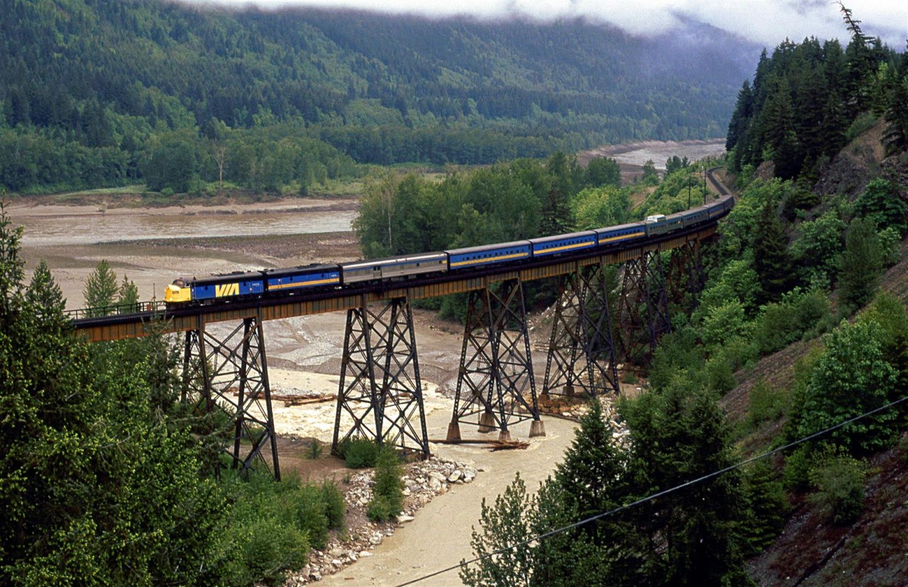 The westbound "Super Continental" crosses the Anderson Creek bridge just south of Boston Bar. The high water levels in the creek and Fraser River suggest that it has been raining a lot lately and that the Spring thaw is well underway.