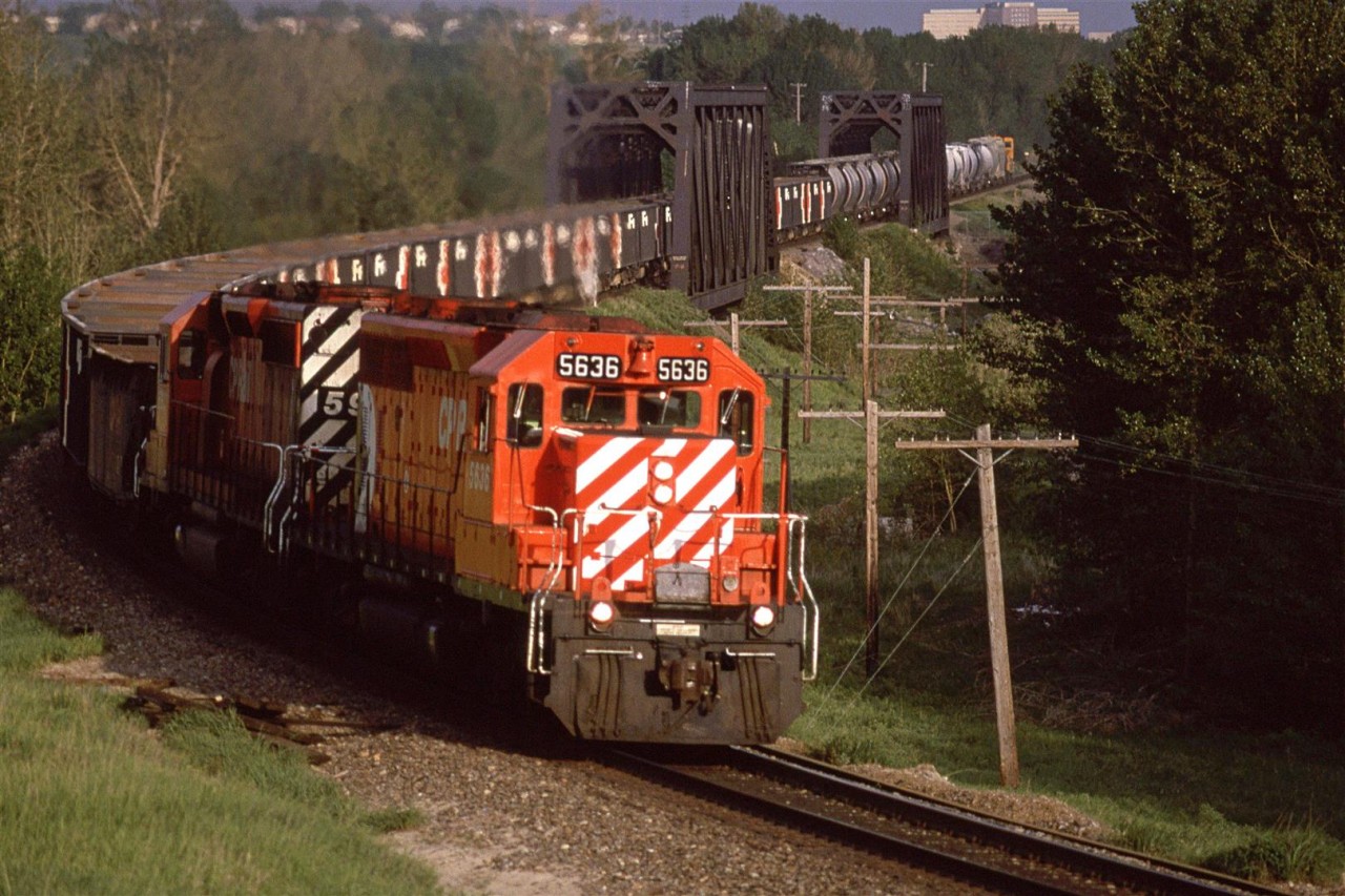 An eastbound "Exshaw Turn" (?) with SD-40's leading was a rare occurrence. The short train with aggregate gondolas and Hoppers for cement powder are a dead giveaway that this train is headed to Exshaw. Judging by the light, it seems to be running several hours late. Perhaps that explains the 6 axle power this day.
