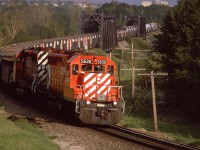 An eastbound "Exshaw Turn" (?) with SD-40's leading was a rare occurrence. The short train with aggregate gondolas and Hoppers for cement powder are a dead giveaway that this train is headed to Exshaw. Judging by the light, it seems to be running several hours late. Perhaps that explains the 6 axle power this day.