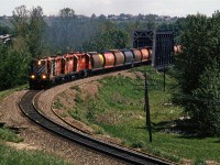 Another shot of the "Exshaw Turn" crossing the Bow River in west Calgary.
The grain hoppers will likely be dropped off at Kieth yard, since there are no grain handling facilities on the Laggan Sub.
The High-nose GP-9 was a treat to catch on this train. I would see them periodically in the yard, but they didn not seem to show up in front of my lens very often.