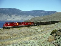 2 relatively new AC44CW's in CP's Golden Beaver paint scheme lead a loaded coal train west along the south shore of Kamloops Lake approaching Savona, BC on a very hot August 29, 1998