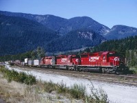 3 SD40's leading an westbound intermodal west of Yale, BC.  There was a time when 3 SD's was so commonplace that it was disappointing. However by the 90's we were happy to not see a wide cab on this one.