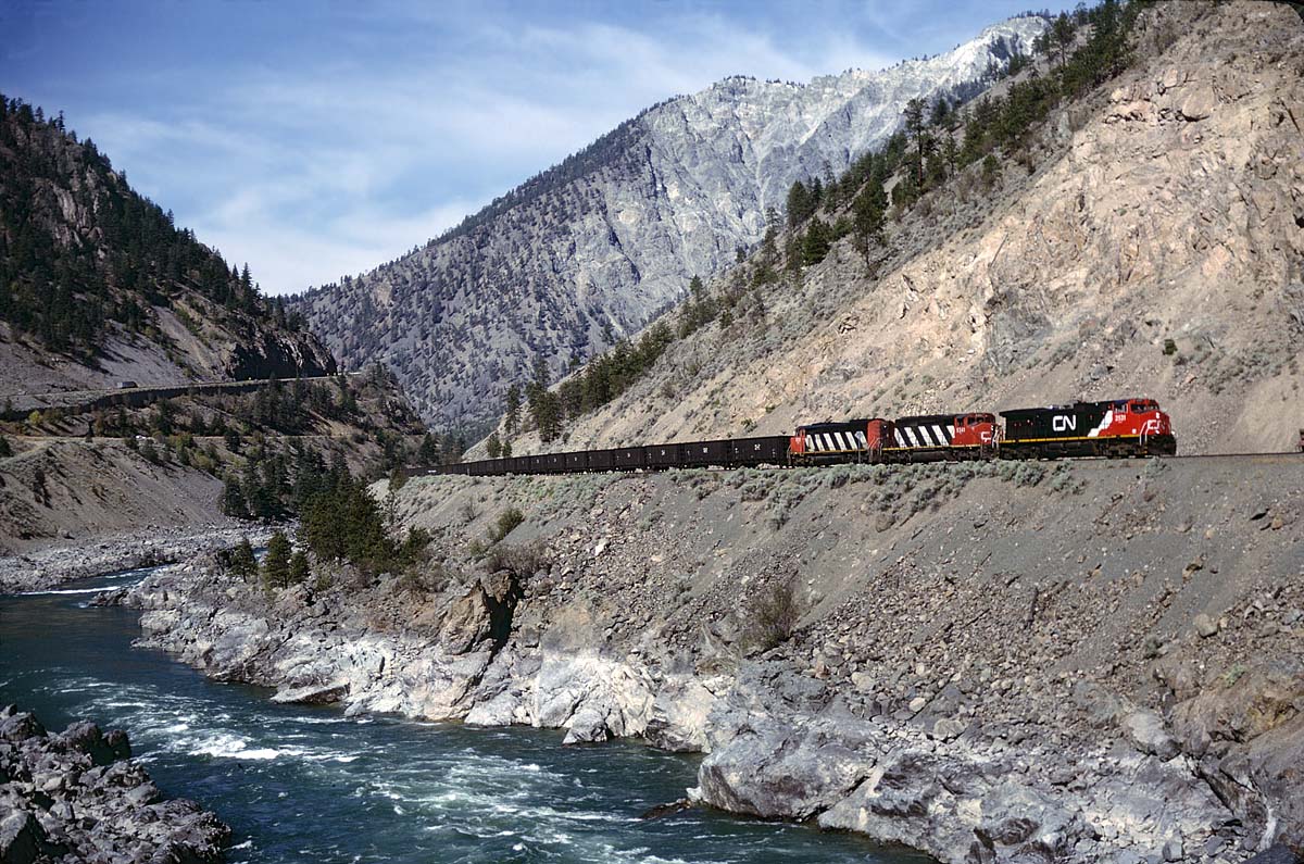 A just over a year old C44-9W leading 2 EMD's and an empty hopper train through the Thompson River valley a few miles east of Lytton