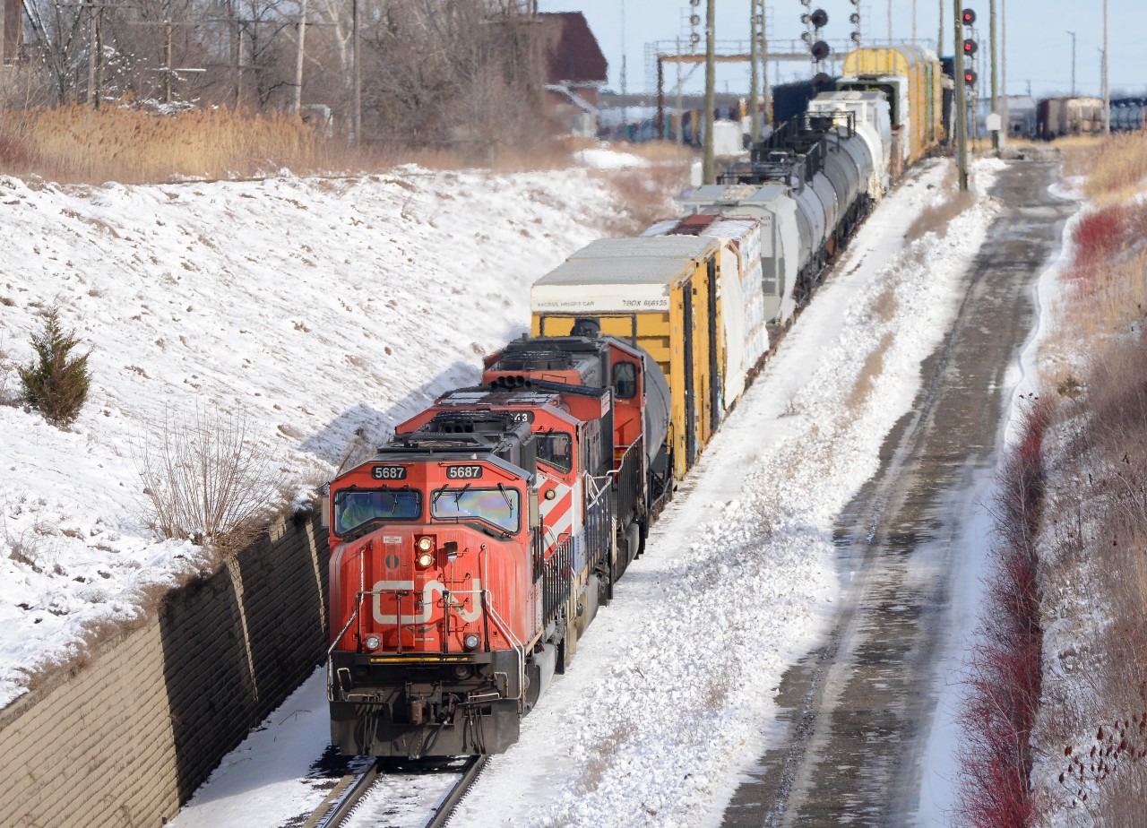 Train 385 heads west towards the St. Clair River Tunnel to Port Huron, MI., with CN 5687, BCOL 4643 and CN 5633.